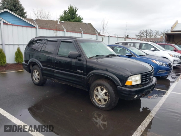 1999 Oldsmobile Bravada z VIN 1GHDT13W0X2712225, wystawiony jako IAAI lot #41550117 z przebiegiem 170 706 mil mil oraz . Historia ofert i sprzedaży dostępna na DreamBid. Obrazek 1.