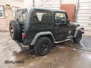 2003 Jeep Wrangler Sport Right Hand Drive with VIN 1J4F449S63P359031, listed as a IAAI auction lot 41495087 with 126,678 mi miles. Bid and sale history available at carsss.com. Image 4.