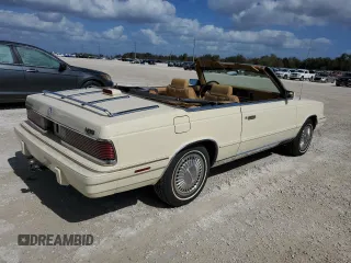 1986 Chrysler LeBaron z VIN 1C3BC55D0GG153072, wystawiony jako Copart lot #77865854 z przebiegiem 74 922 mil mil oraz Szkoda całkowita • Salvage title. Historia ofert i sprzedaży dostępna na DreamBid. Obrazek 3.
