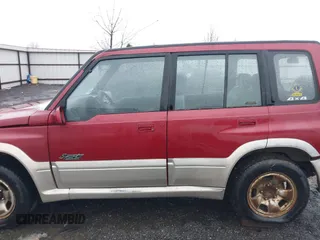 1996 Suzuki Sidekick z VIN JS3TD21V0T4107927, wystawiony jako IAAI lot #41249522 z przebiegiem 225 665 mil mil oraz . Historia ofert i sprzedaży dostępna na DreamBid. Obrazek 14.