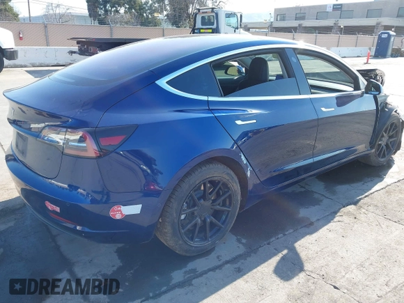 2018 Tesla Model 3 Long Range Battery with VIN 5YJ3E1EA4JF011799, listed as a IAAI auction lot 41765860 with 133,098 mi miles. Bid and sale history available at carsss.com. Image 4.