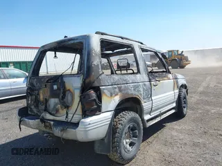 1991 Mitsubishi Montero z VIN 2BG70124X43000753, wystawiony jako IAAI lot #42055421 z przebiegiem Nie podano mil oraz . Historia ofert i sprzedaży dostępna na DreamBid. Obrazek 4.