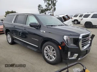 2023 GMC Yukon XL SLT with VIN 1GKS2GKD5PR363433, listed as a Copart auction lot 85979734 with 61,957 mi miles and Salvage Title. Bid and sale history available at DreamBid. Image 4.
