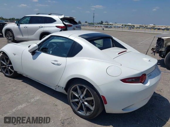 2021 Mazda MX-5 Miata Grand Touring z VIN JM1NDAM75M0450871, wystawiony jako IAAI lot #42060495 z przebiegiem 48 670 mil mil oraz . Historia ofert i sprzedaży dostępna na DreamBid. Obrazek 3.