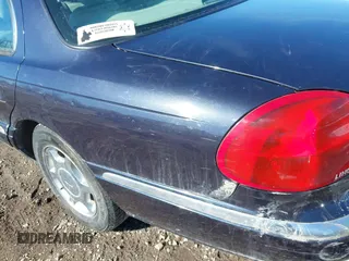 1999 Lincoln Continental with VIN 1LNHM97V8XY700644, listed as a IAAI auction lot 41641082 with 142,527 mi miles. Bid and sale history available at carsss.com. Image 12.