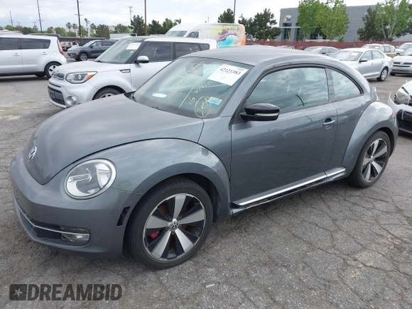 2012 Volkswagen Beetle 2.0T Turbo w/Sun/Snd/Nav PZEV with VIN 3VWVA7AT5CM653829, listed as a IAAI auction lot 42121383 with 114,474 mi miles. Bid and sale history available at carsss.com. Image 2.