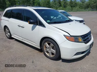 2013 Honda Odyssey Touring with VIN 5FNRL5H94DB009418, listed as a IAAI auction lot 42451425 with 212,623 mi miles and . Bid and sale history available at DreamBid. Image 1.