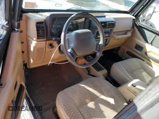 1999 Jeep Wrangler Sport with VIN 1J4FY19S6XP445867, listed as a Copart auction lot 62223125 with 146,037 mi miles and Salvage title. Bid and sale history available at DreamBid. Image 8.