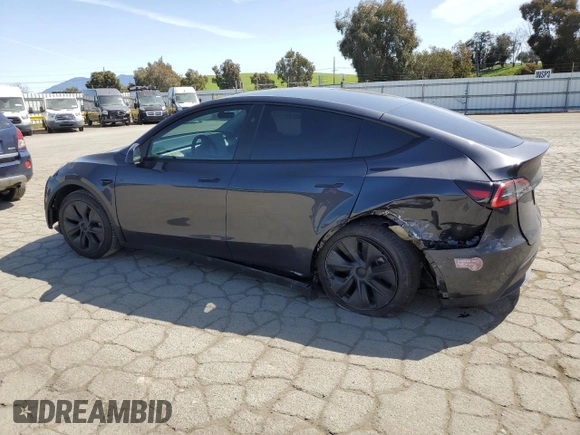 2025 Tesla Model Y Long Range with VIN 7SAYGDED4SF240354, listed as a Copart auction lot 52049745 with 6,785 mi miles and Salvage Title. Bid and sale history available at DreamBid. Image 2.