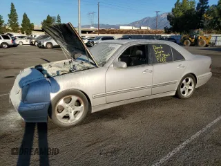 2002 Mercedes-Benz E-Class with VIN WDBJF65J32B496411, listed as a Copart auction lot 75690884 with 128,855 mi miles and Salvage Title. Bid and sale history available at carsss.com. Image 1.