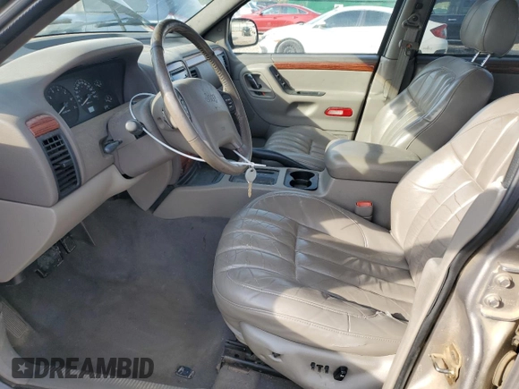 1999 Jeep Grand Cherokee Limited with VIN 1J4G268S7XC668348, listed as a Copart auction lot 77824084 with 165,779 mi miles and Salvage title. Bid and sale history available at DreamBid. Image 7.