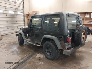 2003 Jeep Wrangler Sport Right Hand Drive with VIN 1J4F449S63P359031, listed as a IAAI auction lot 41495087 with 126,678 mi miles. Bid and sale history available at carsss.com. Image 3.