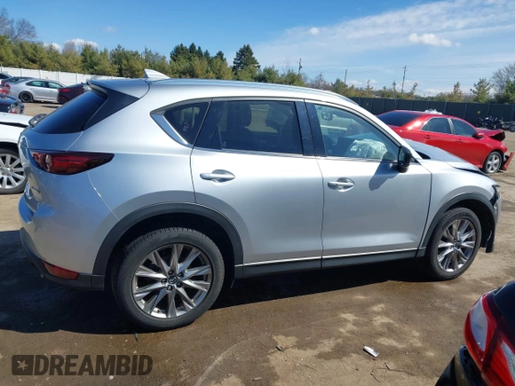 2021 Mazda CX-5 Grand Touring with VIN JM3KFBDM3M1300316, listed as a IAAI auction lot 41878520 with 77,670 mi miles and . Bid and sale history available at DreamBid. Image 13.