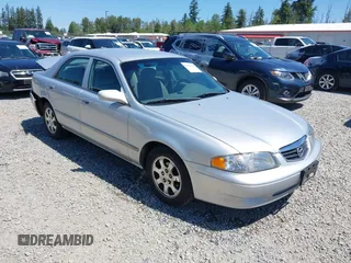 2002 Mazda 626 LX z VIN 1YVGF22C925291467, wystawiony jako IAAI lot #42369106 z przebiegiem 155 829 mil mil oraz . Historia ofert i sprzedaży dostępna na DreamBid. Obrazek 1.