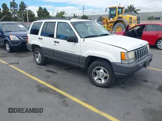 1996 Jeep Grand Cherokee Laredo z VIN 1J4FX58S5TC388512, wystawiony jako IAAI lot #42803796 z przebiegiem 147 732 mil mil oraz . Historia ofert i sprzedaży dostępna na DreamBid. Obrazek 1.