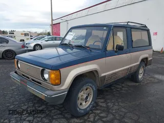 1986 Isuzu Trooper z VIN JACCH55L1G7801560, wystawiony jako IAAI lot #41878592 z przebiegiem 139 020 mil mil oraz . Historia ofert i sprzedaży dostępna na DreamBid. Obrazek 2.