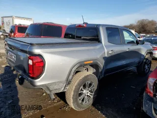 2023 GMC Canyon 4WD AT4 with VIN 1GTP6DEK5P1170230, listed as a Copart auction lot 42701935 with 26,704 mi miles and Salvage Title. Bid and sale history available at carsss.com. Image 3.
