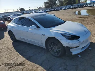 2020 Tesla Model 3 Standard Range Plus with VIN 5YJ3E1EA5LF660417, listed as a Copart auction lot 48144125 with 112,924 mi miles and Salvage Title. Bid and sale history available at DreamBid. Image 4.