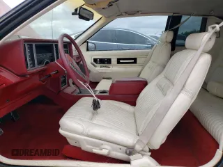 1986 Cadillac Eldorado z VIN 1G6EL5784GU616263, wystawiony jako Copart lot #48741325 z przebiegiem 59 213 mil mil oraz Tytuł czysty. Historia ofert i sprzedaży dostępna na DreamBid. Obrazek 7.