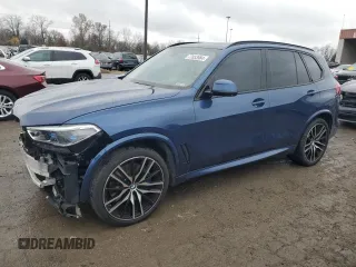 2020 BMW X5 M50i with VIN 5UXJU4C07LLE46002, listed as a Copart auction lot 77853984 with 74,098 mi miles and Salvage Title. Bid and sale history available at carsss.com. Image 1.