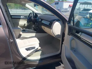 2014 Volkswagen Touareg Sport with VIN WVGEF9BP7ED003525, listed as a IAAI auction lot 41868307 with 74,379 mi miles and . Bid and sale history available at DreamBid. Image 5.