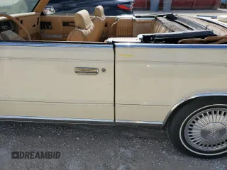 1986 Chrysler LeBaron z VIN 1C3BC55D0GG153072, wystawiony jako Copart lot #77865854 z przebiegiem 74 922 mil mil oraz Szkoda całkowita • Salvage title. Historia ofert i sprzedaży dostępna na DreamBid. Obrazek 12.