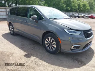 2023 Chrysler Pacifica Hybrid Touring L z VIN 2C4RC1L73PR522988, wystawiony jako IAAI lot #42280263 z przebiegiem 54 939 mil mil oraz . Historia ofert i sprzedaży dostępna na DreamBid. Obrazek 1.