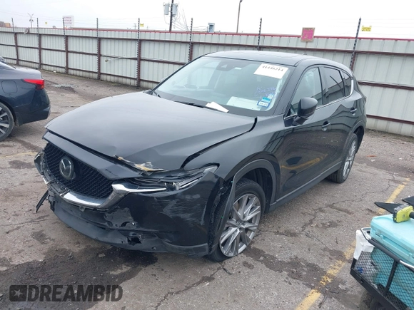2020 Mazda CX-5 Grand Touring with VIN JM3KFADM8L0811910, listed as a IAAI auction lot 41446214 with 57,849 mi miles. Bid and sale history available at carsss.com. Image 2.