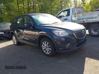 2016 Mazda CX-5 Sport with VIN JM3KE2BY3G0657904, listed as a IAAI auction lot 42127897 with 153,855 mi miles. Bid and sale history available at carsss.com. Image 1.