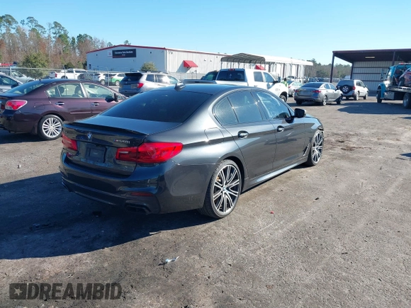 2018 BMW 5 Series M550i xDrive with VIN WBAJB9C57JG463933, listed as a IAAI auction lot 41295711 with 99,173 mi miles and . Bid and sale history available at carsss.com. Image 4.