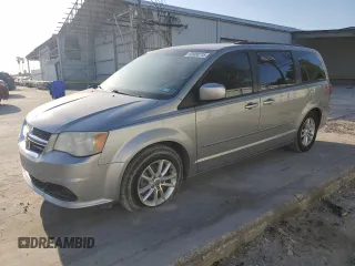 2014 Dodge Grand Caravan SXT with VIN 2C4RDGCG1ER121033, listed as a Copart auction lot 52030715 with 105,451 mi miles and Salvage Title. Bid and sale history available at DreamBid. Image 1.