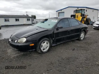 1998 Ford Taurus LX z VIN 1FAFP52U2WG121539, wystawiony jako Copart lot #57262785 z przebiegiem 124 902 mil mil oraz Szkoda całkowita • Salvage title. Historia ofert i sprzedaży dostępna na DreamBid. Obrazek 1.