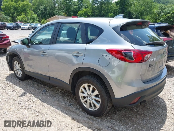 2014 Mazda CX-5 Sport with VIN JM3KE2BEXE0329303, listed as a IAAI auction lot 42556908 with 127,836 mi miles and . Bid and sale history available at DreamBid. Image 3.