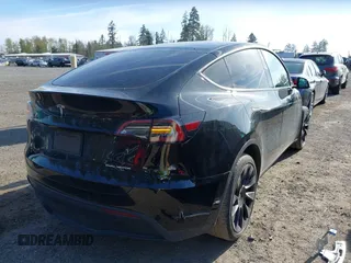 2021 Tesla Model Y Long Range with VIN 5YJYGDEE9MF301903, listed as a IAAI auction lot 42004007 with 26,740 mi miles. Bid and sale history available at carsss.com. Image 4.