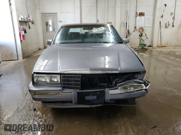 1991 Cadillac Seville z VIN 1G6KS53B2MU809384, wystawiony jako Copart lot #77185134 z przebiegiem 134 769 mil mil oraz Szkody całkowita. Historia ofert i sprzedaży dostępna na DreamBid. Obrazek 5.