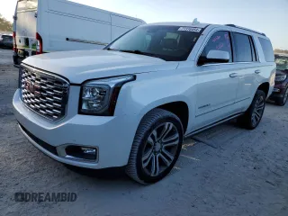 2019 GMC Yukon Denali with VIN 1GKS1CKJ8KR353280, listed as a Copart auction lot 77316454 with 74,476 mi miles and Salvage Title. Bid and sale history available at carsss.com. Image 1.