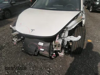 2020 Tesla Model 3 Standard Range Plus with VIN 5YJ3E1EA4LF792830, listed as a IAAI auction lot 41852919 with 76,461 mi miles. Bid and sale history available at carsss.com. Image 6.