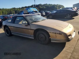 1987 Pontiac Fiero GT z VIN 1G2PG119XHP200243, wystawiony jako Copart lot #74389864 z przebiegiem 109 478 mil mil oraz Tytuł czysty. Historia ofert i sprzedaży dostępna na DreamBid. Obrazek 4.