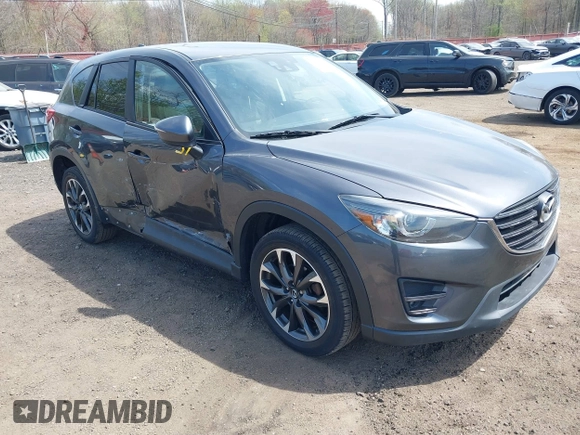 2016 Mazda CX-5 Grand Touring z VIN JM3KE4DY1G0893119, wystawiony jako IAAI lot #42049614 z przebiegiem 102 506 mil mil oraz . Historia ofert i sprzedaży dostępna na DreamBid. Obrazek 1.