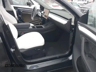 2025 Tesla Model Y Long Range with VIN 7SAYGDED8SA340082, listed as a IAAI auction lot 41915369 with 7,296 mi miles and . Bid and sale history available at carsss.com. Image 5.