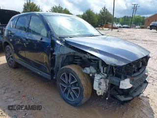 2018 Mazda CX-5 Grand Touring z VIN JM3KFADM8J1406007, wystawiony jako IAAI lot #42008567 z przebiegiem 110 661 mil mil oraz . Historia ofert i sprzedaży dostępna na DreamBid. Obrazek 1.