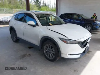 2020 Mazda CX-5 Grand Touring with VIN JM3KFBDM2L0863944, listed as a IAAI auction lot 42150805 with 63,932 mi miles and . Bid and sale history available at DreamBid. Image 1.