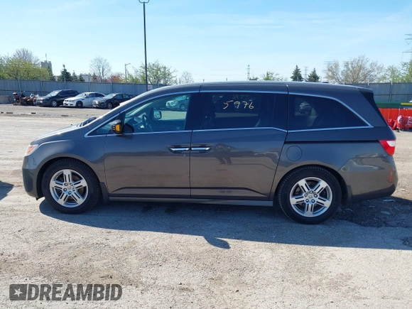 2012 Honda Odyssey Touring with VIN 5FNRL5H9XCB077351, listed as a IAAI auction lot 42045976 with 146,290 mi miles and . Bid and sale history available at DreamBid. Image 14.