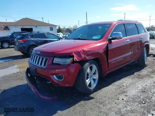 2014 Jeep Grand Cherokee Overland with VIN 1C4RJFCG2EC216406, listed as a IAAI auction lot 41944794 with 124,007 mi miles. Bid and sale history available at carsss.com. Image 2.