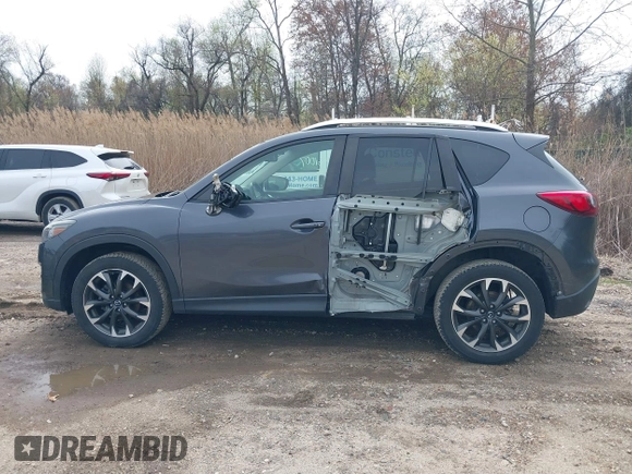 2016 Mazda CX-5 Grand Touring with VIN JM3KE4DYXG0830150, listed as a IAAI auction lot 41961007 with 142,570 mi miles and . Bid and sale history available at DreamBid. Image 14.