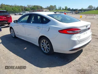 2017 Ford Fusion Hybrid SE z VIN 3FA6P0LU8HR396572, wystawiony jako IAAI lot #41997684 z przebiegiem 272 803 mil mil oraz . Historia ofert i sprzedaży dostępna na DreamBid. Obrazek 3.