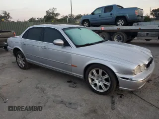 2004 Jaguar XJ with VIN SAJEA71C54SG01326, listed as a Copart auction lot 77449324 with 72,935 mi miles and Salvage Title. Bid and sale history available at carsss.com. Image 4.