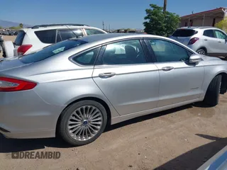 2014 Ford Fusion Titanium Hybrid with VIN 3FA6P0RUXER103516, listed as a IAAI auction lot 42004602 with 128,287 mi miles and . Bid and sale history available at carsss.com. Image 13.