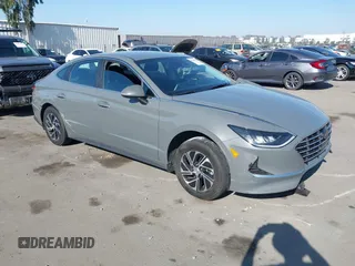 2022 Hyundai Sonata Hybrid Blue with VIN KMHL24JJ1NA041773, listed as a IAAI auction lot 41043553 with 23,696 mi miles. Bid and sale history available at carsss.com. Image 1.