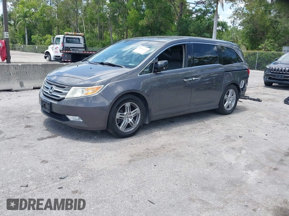 2013 Honda Odyssey Touring with VIN 5FNRL5H96DB068843, listed as a IAAI auction lot 42312176 with 115,804 mi miles and . Bid and sale history available at DreamBid. Image 2.